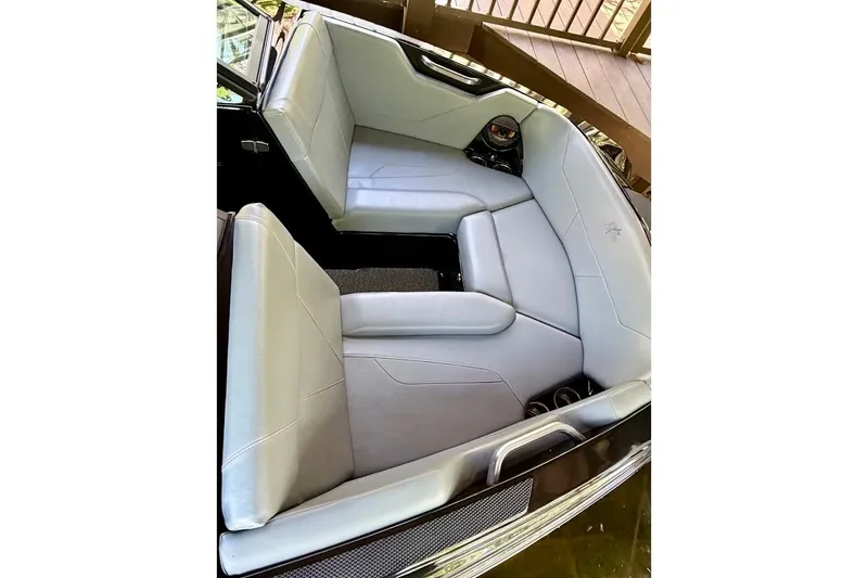 Slide: The Image of 2023 MasterCraft NXT20 boat interior with sleek gray seating and modern design. - 14