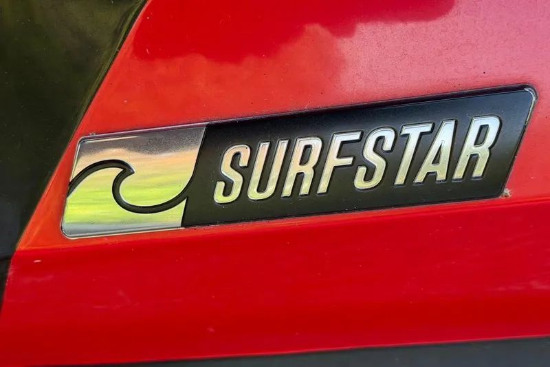 Slide: The Image of 2023 MasterCraft NXT20 SurfStar logo on red background. - 20
