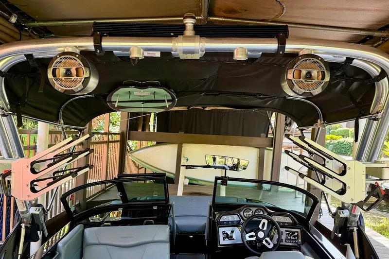 Slide: The Image of 2023 MasterCraft NXT20 boat interior with speakers and wakeboard racks. - 23