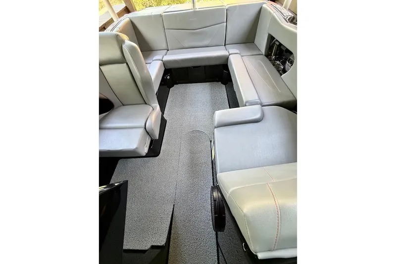 Slide: The Image of 2023 MasterCraft NXT20 boat interior with gray seating and carpeted floor. - 30
