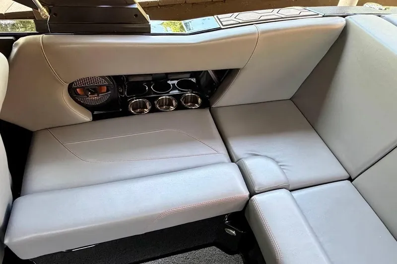 Slide: The Image of 2023 MasterCraft NXT20 boat interior with gray seating and cup holders. - 31