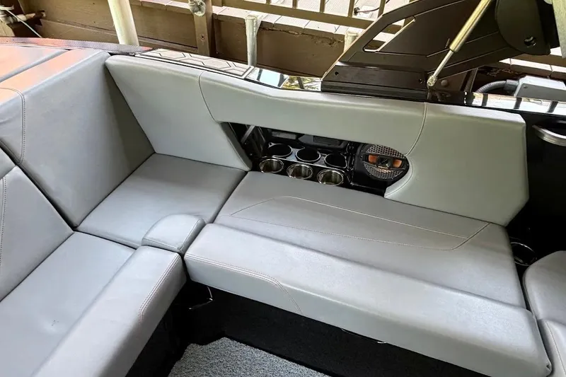Slide: The Image of 2023 MasterCraft NXT20 boat interior with gray seating and cup holders. - 33
