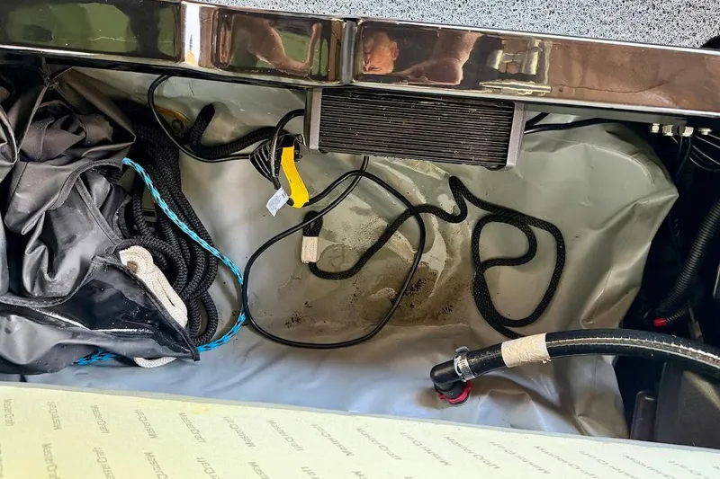 Slide: The Image of Interior view of a 2023 MasterCraft NXT20 boat showing cables and storage area. - 38