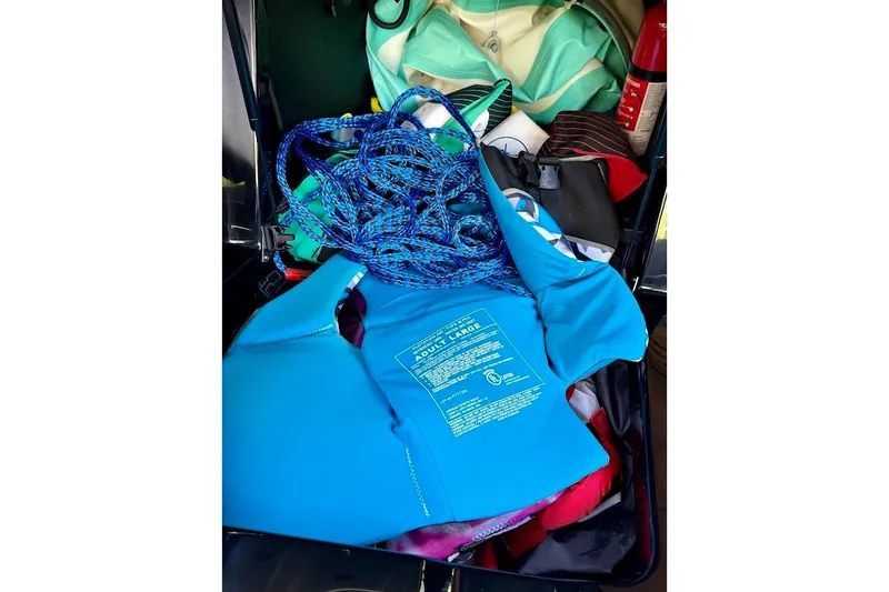 Slide: The Image of Storage compartment of 2023 MasterCraft NXT20 with life jacket and boating gear. - 40