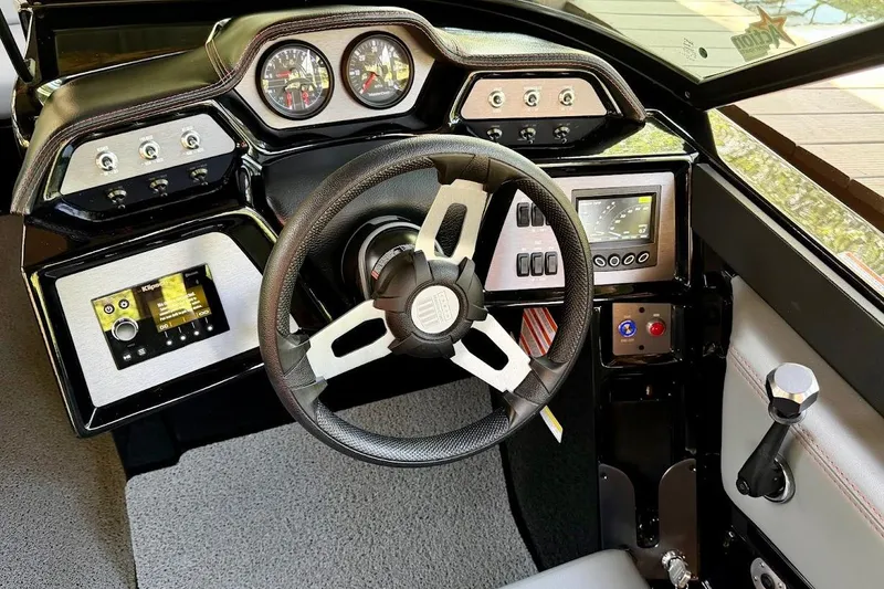 Slide: The Image of 2023 MasterCraft NXT20 boat dashboard with steering wheel and control panels. - 43