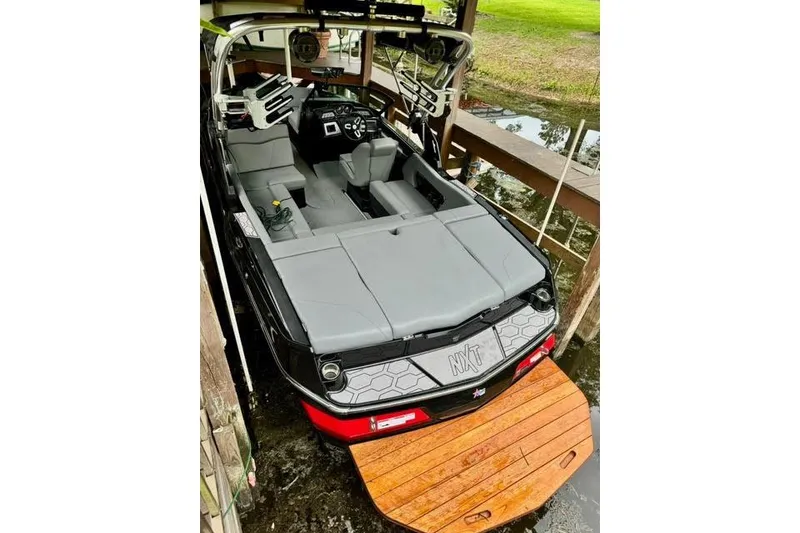 Slide: The Image of 2023 MasterCraft NXT20 boat with sleek interior and wooden swim platform. - 5