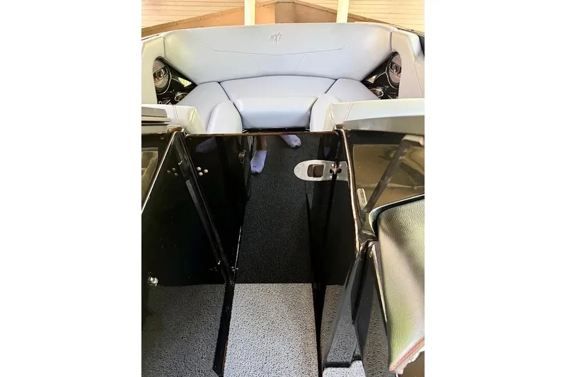 Slide: The Image of 2023 MasterCraft NXT20 boat interior with gray seating and black accents. - 52