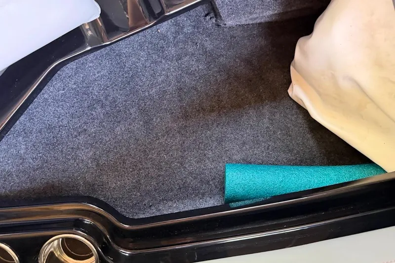 Slide: The Image of Interior storage compartment of 2023 MasterCraft NXT20 boat with carpet lining. - 55