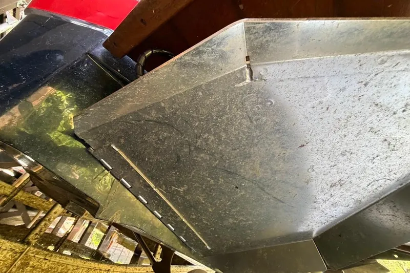 Slide: The Image of 2023 MasterCraft NXT20 boat hull close-up, showcasing metal and fiberglass details. - 57