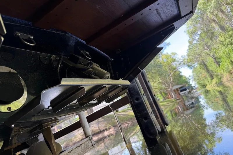 Slide: The Image of Underneath view of a 2023 MasterCraft NXT20 boat near a serene lakeside. - 58