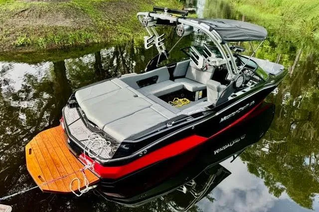Slide: The Image of 2023 MasterCraft NXT20 boat with sleek design, docked on calm water. - 6