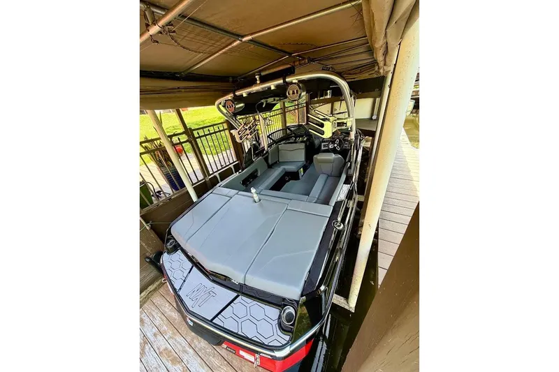 Slide: The Image of 2023 MasterCraft NXT20 boat docked, featuring sleek interior and modern design elements. - 9