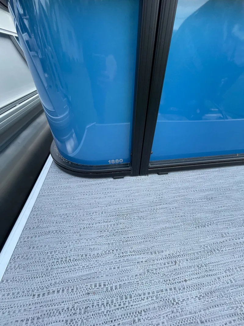 Slide: The Image of Godfrey EX 1880CX CRUISE 2026, blue boat siding and gray flooring. - 10