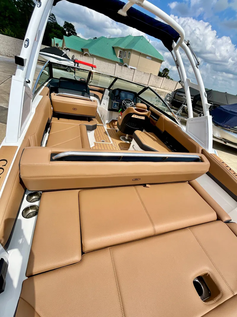 Slide: The Image of Interior of a 2022 Cobalt R4 Outboard boat with brown leather seating. - 11