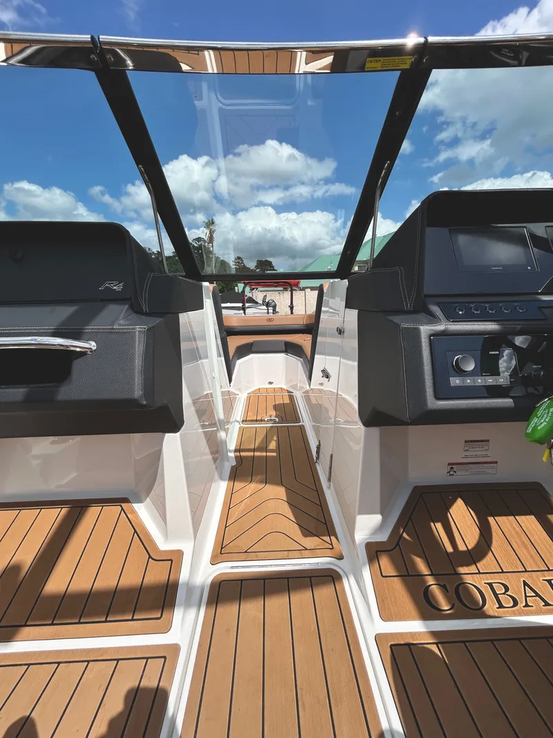 Slide: The Image of Interior view of a 2022 Cobalt R4 Outboard boat with wooden flooring. - 12