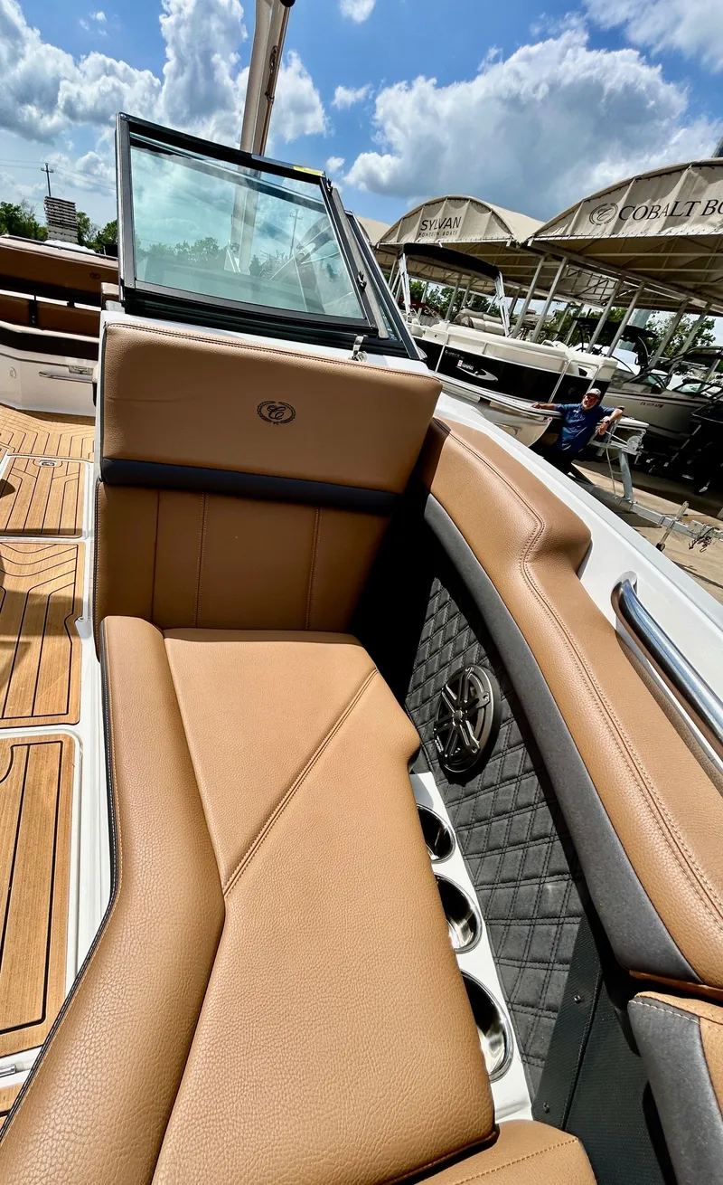 Slide: The Image of Interior of a 2022 Cobalt R4 Outboard boat with brown leather seating. - 20