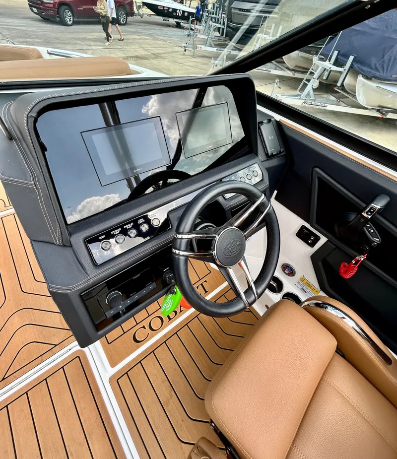 Slide: The Image of Interior of a 2022 Cobalt R4 Outboard with modern helm console. - 27