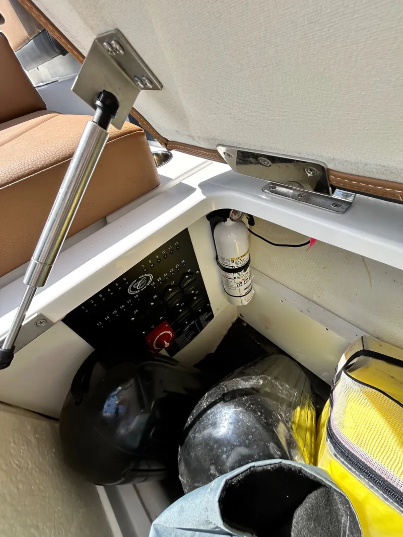 Slide: The Image of Interior of a 2022 Cobalt R4 Outboard with storage and fire extinguisher. - 42