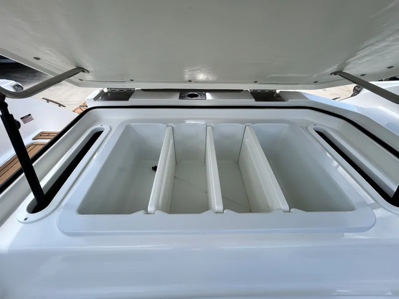 Slide: The Image of Cobalt R4 Outboard 2022 storage compartment with open lid. - 49