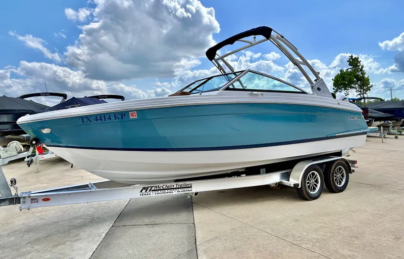 Slide: The Image of 2022 Cobalt R4 Outboard on trailer under blue sky. - 5