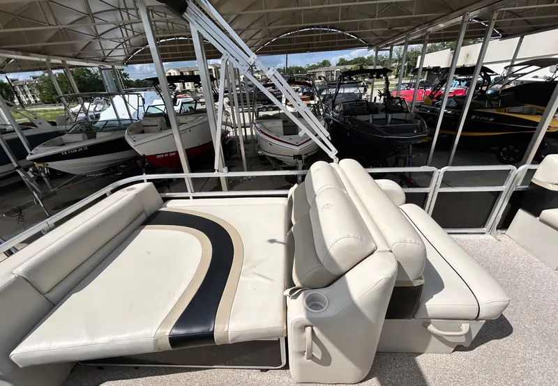 Slide: The Image of 2012 Cypress Cay SEABREEZE 23 pontoon boat with beige seating area in marina. - 31
