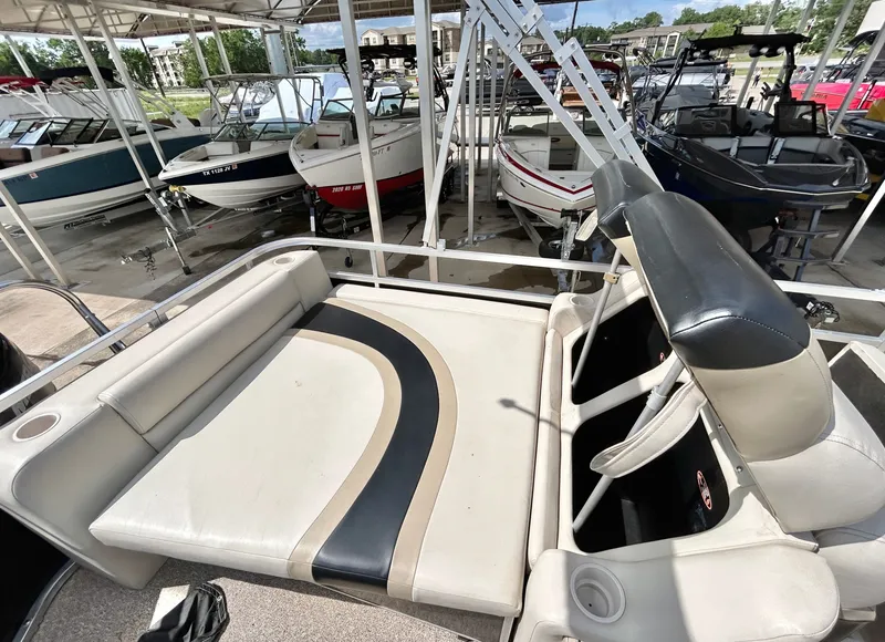 Slide: The Image of 2012 Cypress Cay SEABREEZE 23 pontoon boat with lounge seating in marina. - 33