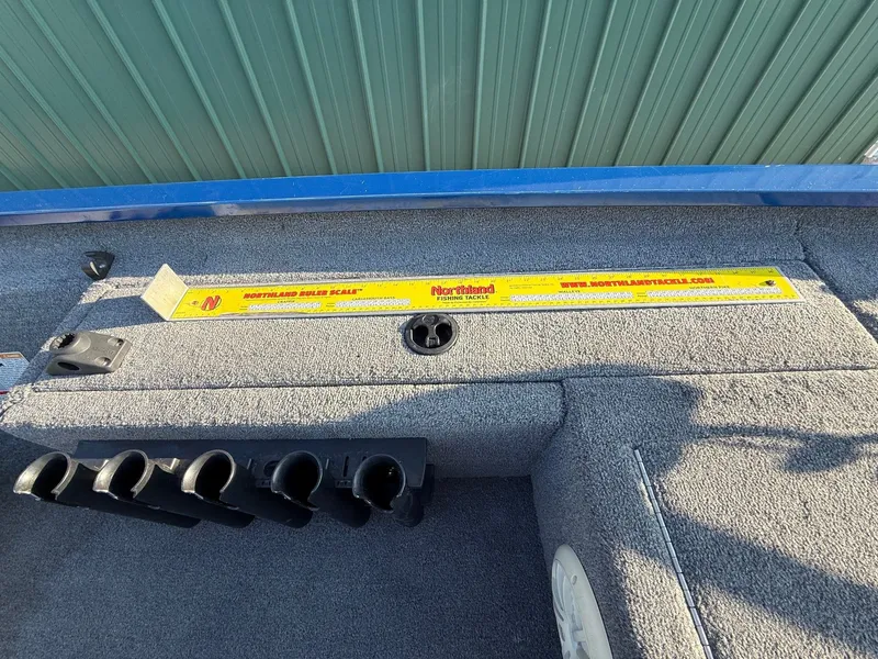 Slide: The Image of Interior view of a 2009 Alumacraft Pro 175 boat with fishing rod holder. - 18