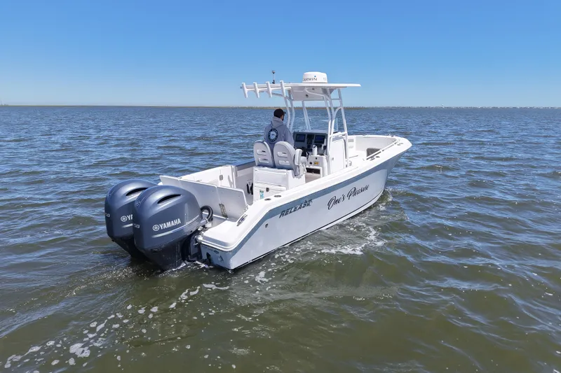 Slide: The Image of 2022 Release 240 RX boat with dual Yamaha engines cruising on open water. - 11