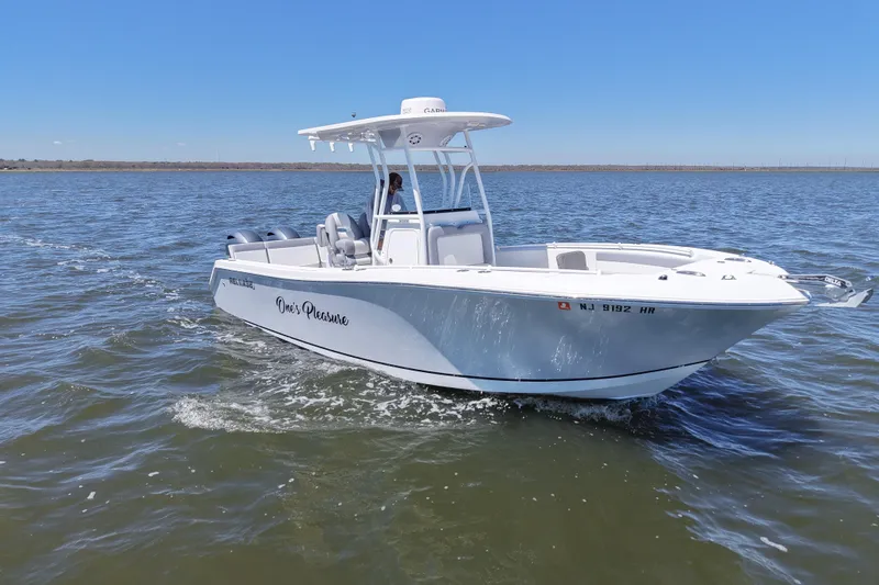 Slide: The Image of A 2022 Release 240 RX boat cruising on open water under a clear blue sky. - 13