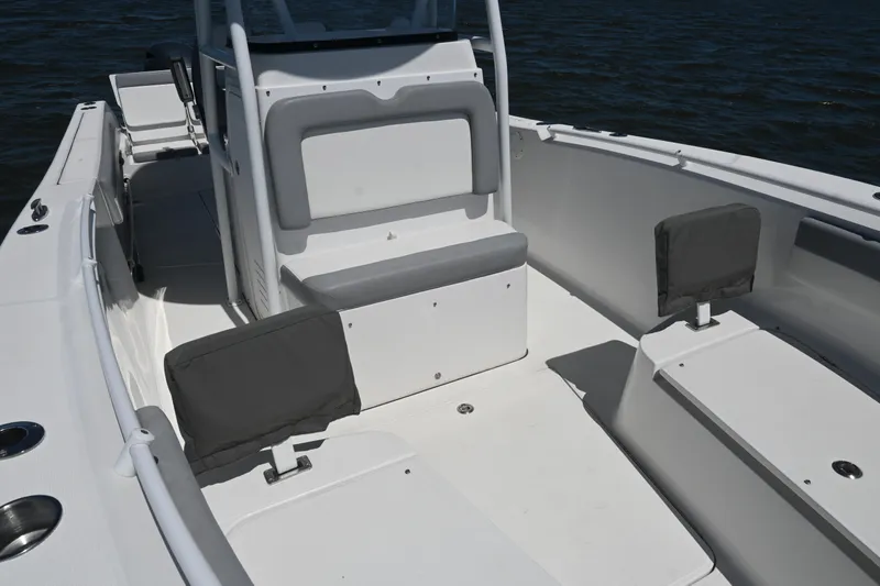 Slide: The Image of 2022 Release 240 RX boat interior with seating and storage, on calm water. - 16