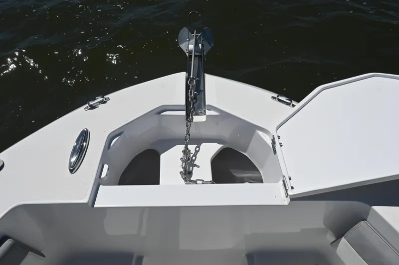 Slide: The Image of Bow of 2022 Release 240 RX boat with anchor chain and storage compartment. - 19