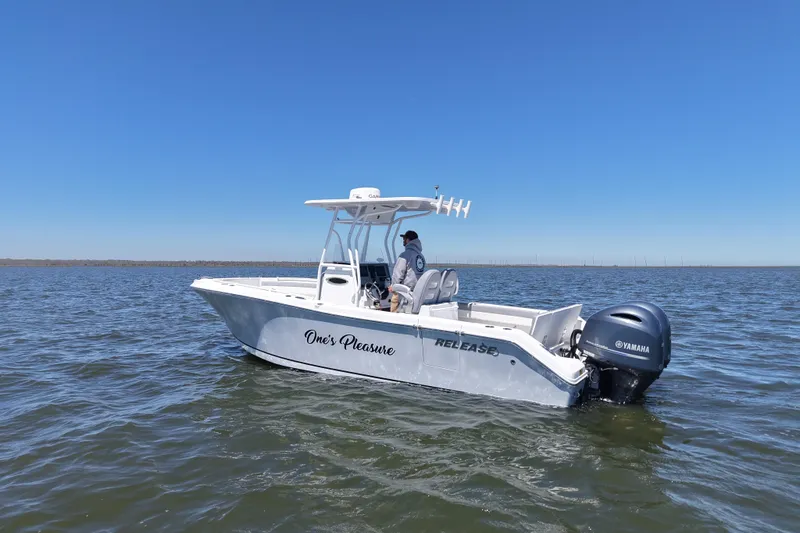 Slide: The Image of 2022 Release 240 RX boat on open water, featuring Yamaha engine under clear blue sky. - 2