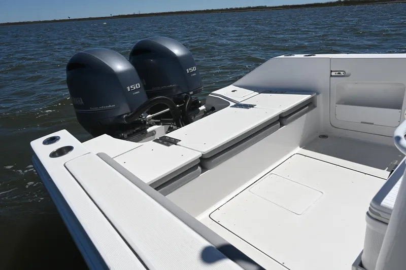 Slide: The Image of 2022 Release 240 RX boat with dual Yamaha 150 engines on open water. - 23