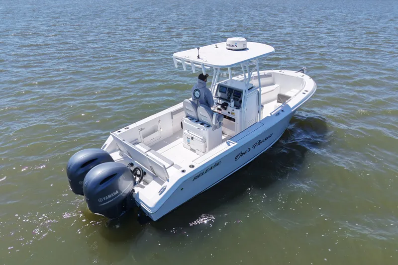Slide: The Image of 2022 Release 240 RX boat on water with dual Yamaha engines. - 3
