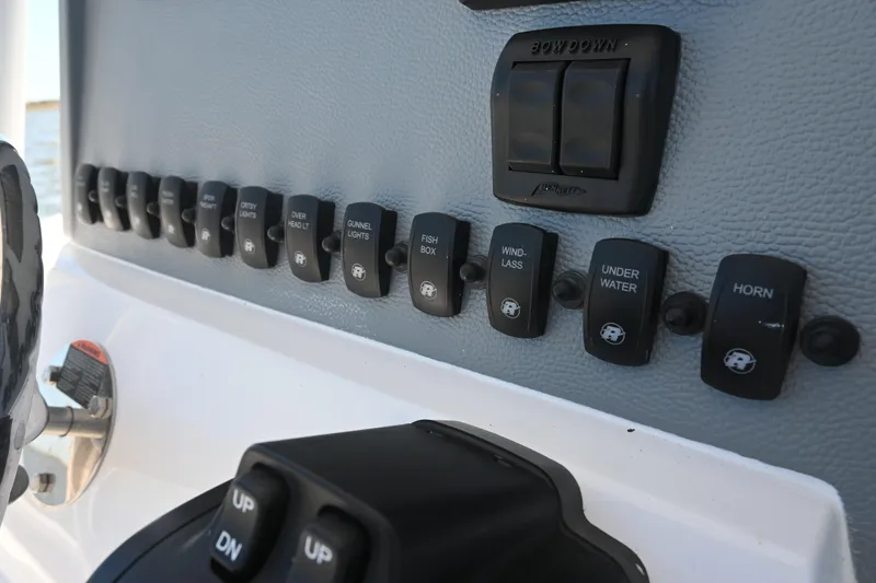 Slide: The Image of Control panel of a 2022 Release 240 RX boat with labeled switches. - 30