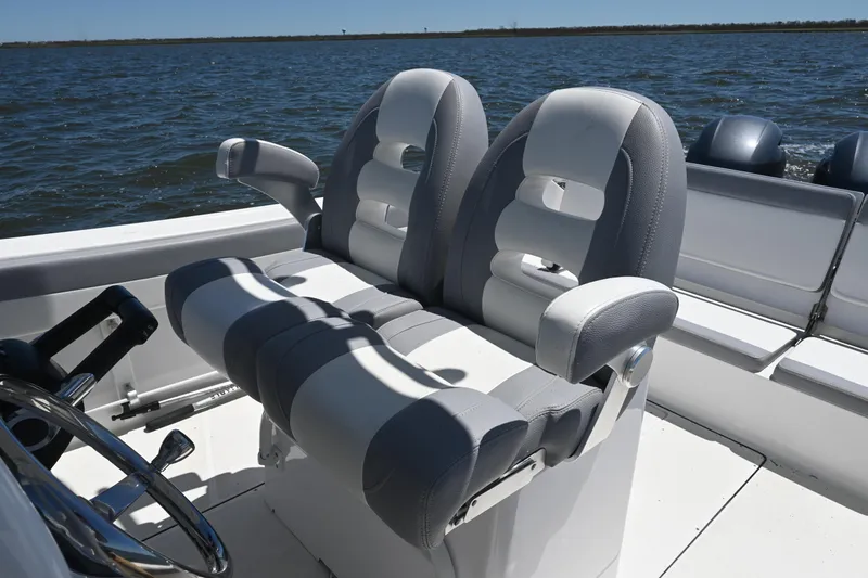 Slide: The Image of 2022 Release 240 RX boat interior with dual cushioned seats on open water. - 32