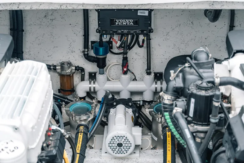 Slide: The Image of Engine compartment of 2024 Lindell 46 boat featuring Volvo Penta components and various mechanical parts. - 14