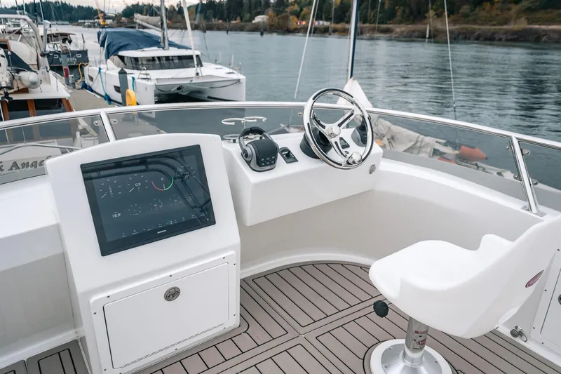 Slide: The Image of Helm of 2024 Lindell 46 boat with steering wheel and navigation display. - 17