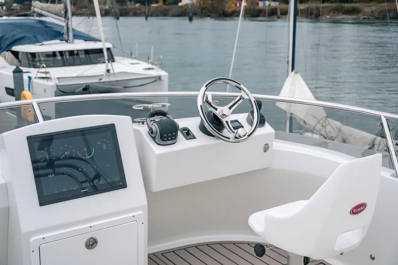 Slide: The Image of Helm of 2024 Lindell 46 boat with modern controls and steering wheel. - 18