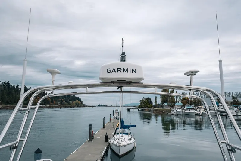 Slide: The Image of Marina view with Garmin-equipped Lindell 46 boat, 2024 model, under cloudy skies. - 20