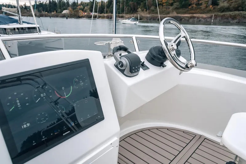 Slide: The Image of 2024 Lindell 46 yacht helm with modern controls and navigation display. - 22