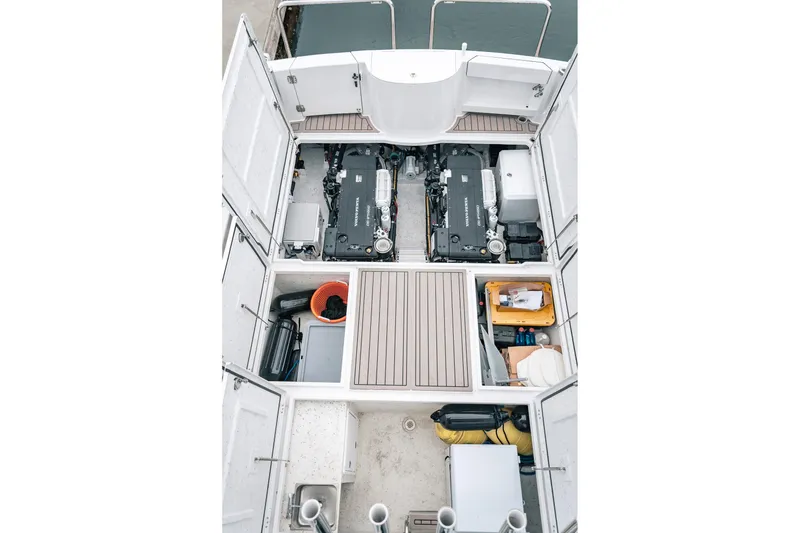 Slide: The Image of Engine compartment of 2024 Lindell 46 boat, showcasing dual engines and storage areas. - 23