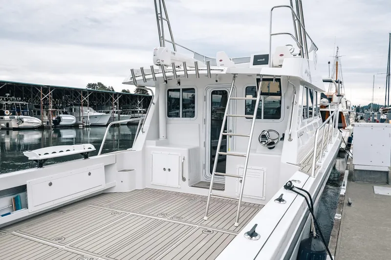 Slide: The Image of 2024 Lindell 46 boat docked at marina, featuring spacious deck and modern design. - 28