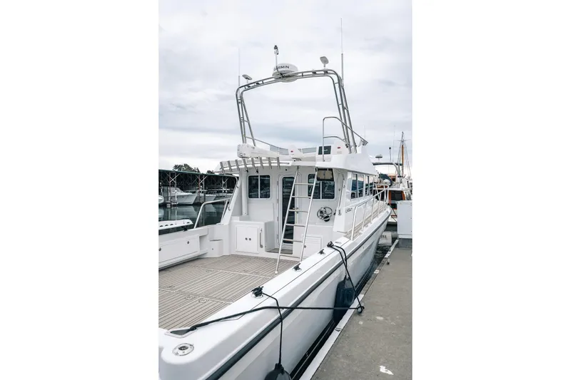 Slide: The Image of 2024 Lindell 46 boat docked at marina, showcasing sleek design and spacious deck. - 29