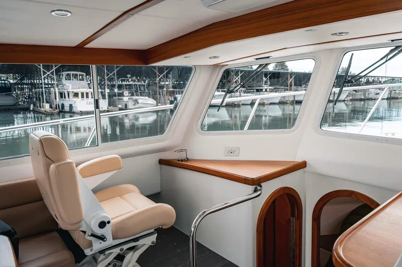 Slide: The Image of Interior of 2024 Lindell 46 yacht with leather seating and marina view. - 3