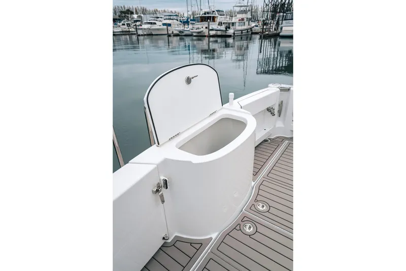 Slide: The Image of 2024 Lindell 46 boat deck with open storage compartment, docked at marina. - 31