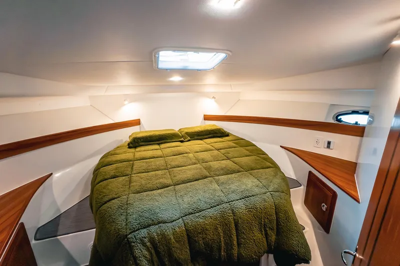 Slide: The Image of Luxurious cabin interior of 2024 Lindell 46 yacht with cozy green bedding. - 33