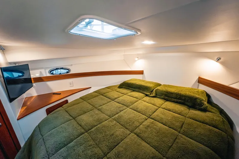 Slide: The Image of Luxurious 2024 Lindell 46 yacht cabin with plush green bedding and modern amenities. - 36