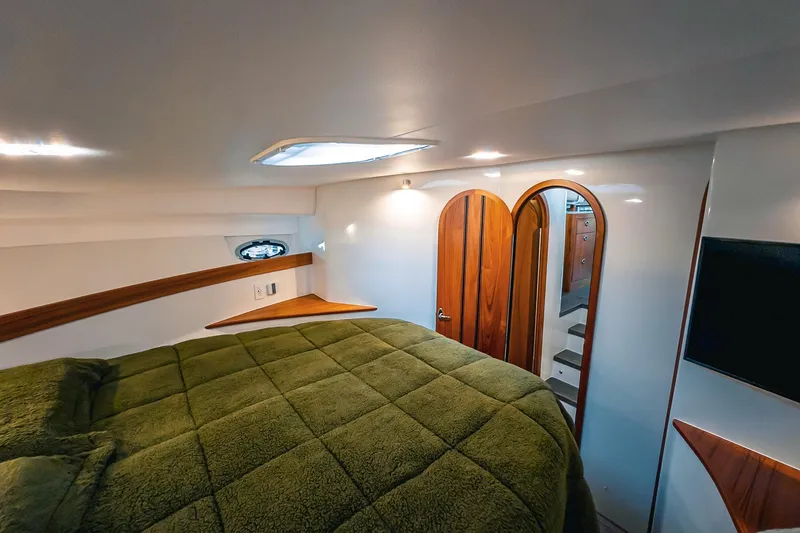 Slide: The Image of Luxurious cabin interior of 2024 Lindell 46 yacht with green bedding and wooden accents. - 37