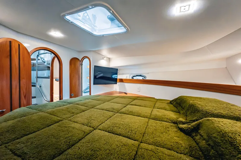 Slide: The Image of Luxurious cabin interior of 2024 Lindell 46 yacht with green bedding and modern amenities. - 45